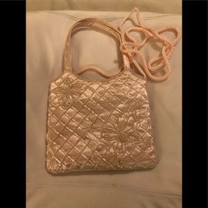 Light pink satin evening bag with pink beads.